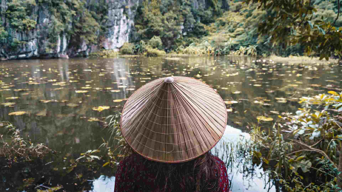 Person wearing woven hat in a boat